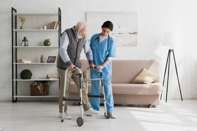 Chiropractor Helping An Elderly Person Walk