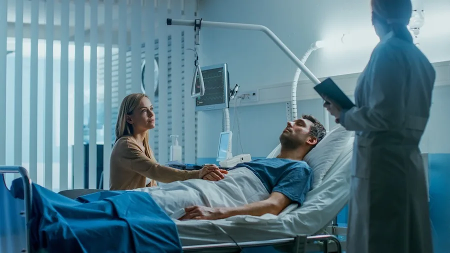 Patient Sleeping In A Hospital Bed