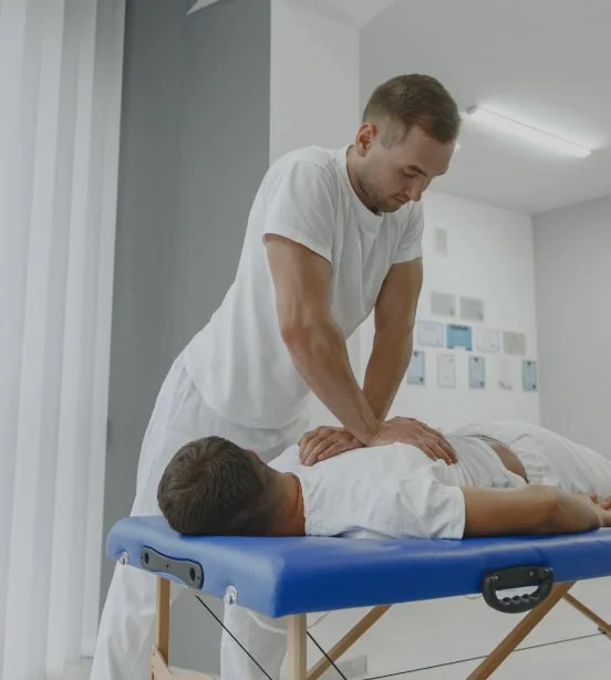 Medical Worker Massaging A Clients Back