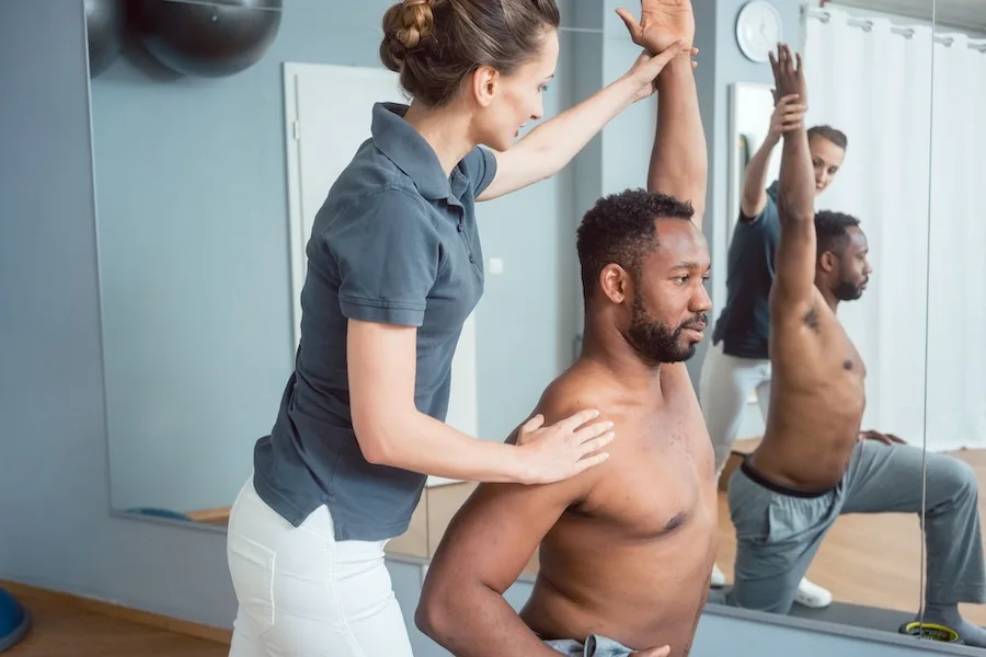 Sports Chiropractor Stretching A Clients Arm